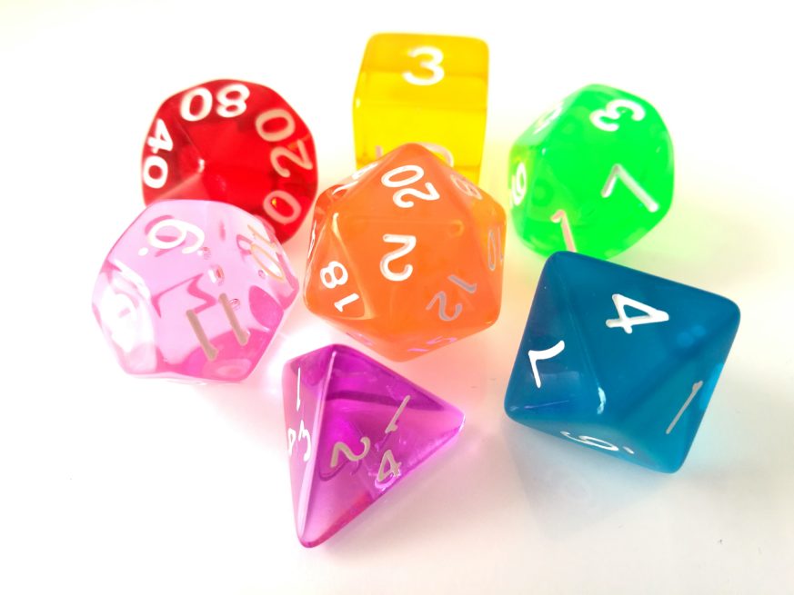 Close-Up Of Colorful Dice Over White Background
