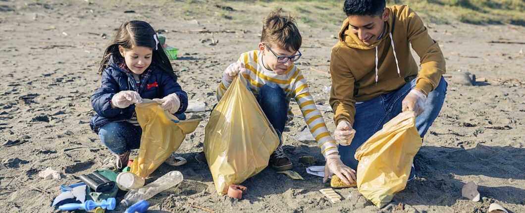 Young volunteers cleaning the beach